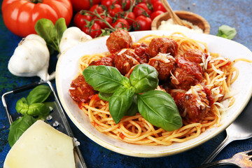 Spaghetti pasta with meatballs and tomato sauce with basil and parmesan