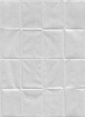Folded white Kraft paper texture. Seamless pattern with a folded and stretched kraft paper texture.