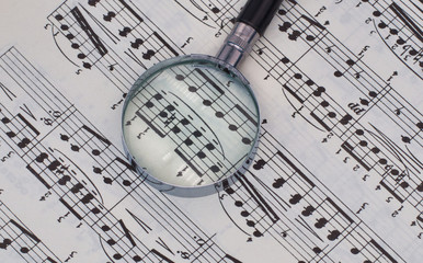musical notation with a magnifier