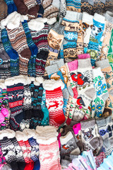 A lot of warm, cozy multi-colored woolen socks, protecting your feet from the cold, selling woolen products in the store and at the fair