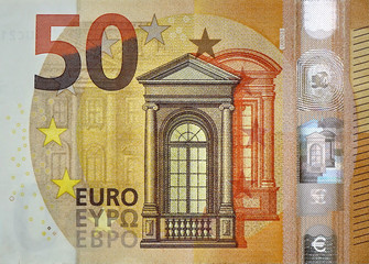 Fragment part of 50 euro banknote close-up with small brown details