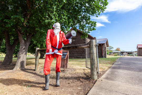 Large Santa Claus doll holding mailbox in Australian outback
