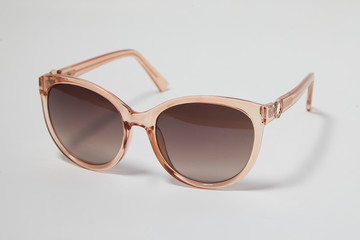 Fashionable female sunglasses on a white background,  close up