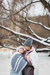 mother and daughter on a winter walk, wrapped in a blanket, forest, field, winter