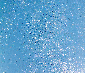 Drops of water on a blue glass window