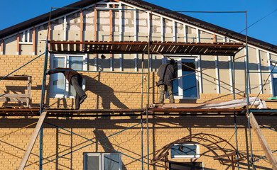 Installation of siding on the walls of the house