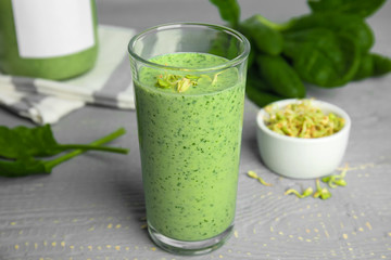 Green buckwheat smoothie on light grey wooden table