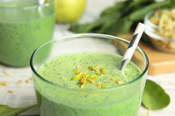 Green buckwheat smoothie on white table, closeup