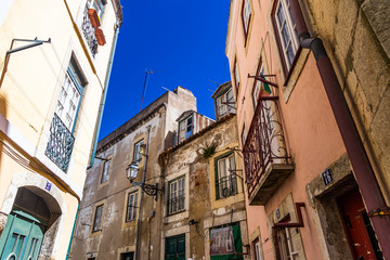 Narrow alley of Lisbon on a summer day with blue sky