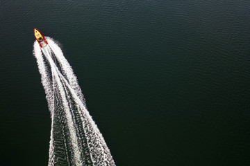 Top down view on speed movement of rescue motorboat.
