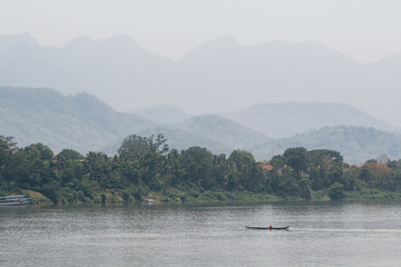 Fototapeta na wymiar Traditional Laotian wooden slow boats on Mekong river near Luang Prabang, Laos