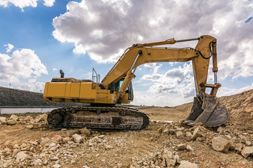Excavator in a quarry extracting stone