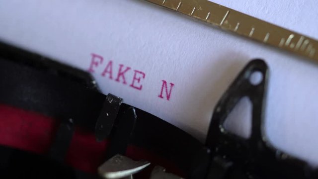 Typing fake news on a vintage typewriter. Close up, selective focus.
