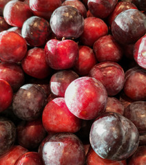 Ripe plum in the store as a background