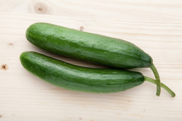 Two Cucumbers on a wooden background.