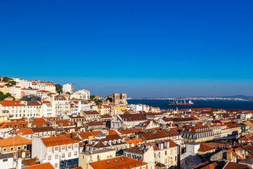 Lisbon skyline with a view at the tagus river and the Cathedral at twilight