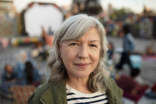 Portrait confident senior woman at movie in the park