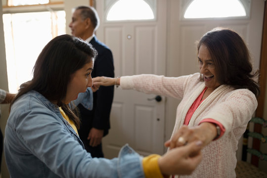 Enthusiastic Latinx woman greeting mother