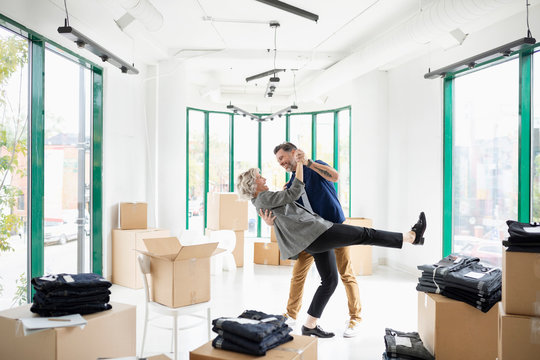 Playful Business Owner Couple Dancing In New Retail Space