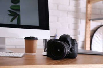 Photographer's workplace with professional camera in office