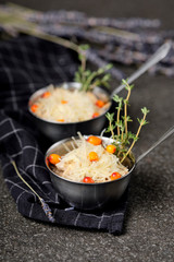 Festive french julienne with sea buckthorn in a bowl on napkin with bunch lavender on stone background. Rustic style. Baked mushroom julienne with chicken and cheese in pots. Top view. Close up