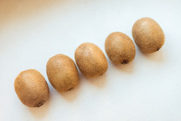 Kiwi fruit on white table, close-up. Top view.