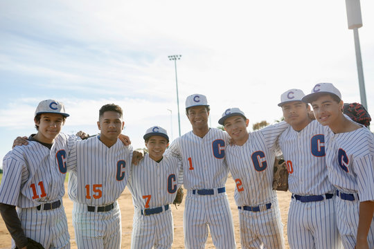 Portrait Confident Baseball Team On Sunny Field