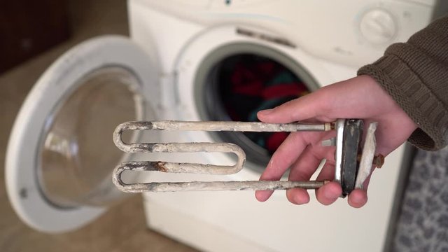 Treatment of Calcium Deposits in Water Heater. Limescale on the heating element for washing machine.  Replacing a heating element