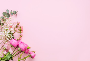 Fototapeta na wymiar Flowers on pink background with copy space