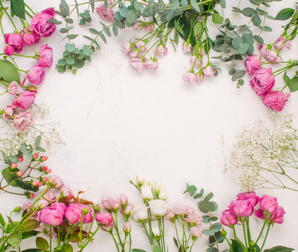 Frame of flowers on white marble background