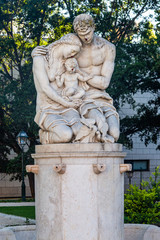 Obraz premium Statue of a mother a father and a child in a public garden in Lisbon, Portugal