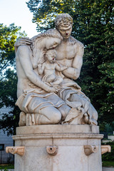 Statue of a mother a father and a child in a public garden in Lisbon, Portugal