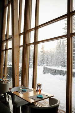Restaurant table by window with snowy view
