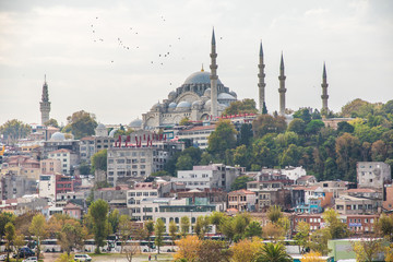  Tourist ship sails on the Golden Horn, Istanbul, Turkey. Scenic sunny panorama of Istanbul city in summer. Beautiful waterfront of Istanbul at sunset. Concept of traveling and vacation in Istanbul.