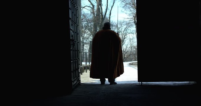 Silhouette of old hetman come out from a fortress