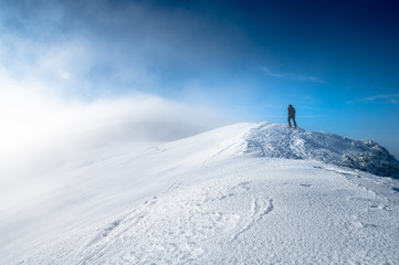 Fototapeta na wymiar Hiker walking alone on the mountains edge. High Quality photo