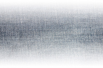 Denim jeans texture of light blue or soft grey color with faded edges. Empty jean fabric background, gradient denim clothes material banner to use as template for advertising 