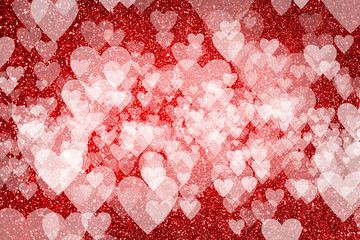 Shiny red background with glitter effect and heart shaped bokeh