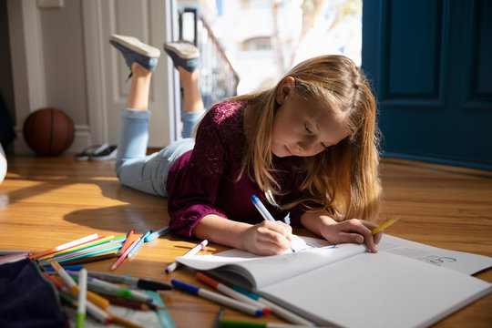 Girl Coloring On Floor