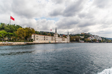 Fototapeta premium Tourist ship sails on the Golden Horn, Istanbul, Turkey. Scenic sunny panorama of Istanbul city in summer. Beautiful waterfront of Istanbul at sunset. Concept of traveling and vacation in Istanbul.