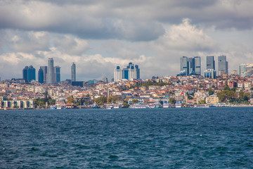 Fototapeta na wymiar Tourist ship sails on the Golden Horn, Istanbul, Turkey. Scenic sunny panorama of Istanbul city in summer. Beautiful waterfront of Istanbul at sunset. Concept of traveling and vacation in Istanbul.