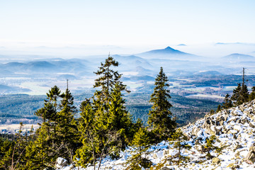 Ralsko Mountain rising from the mist. Weather temperature inversion in Central Bohemian Uplands,...