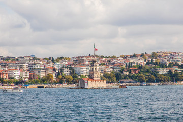 Fototapeta na wymiar Tourist ship sails on the Golden Horn, Istanbul, Turkey. Scenic sunny panorama of Istanbul city in summer. Beautiful waterfront of Istanbul at sunset. Concept of traveling and vacation in Istanbul.