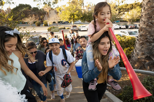 Latinx Baseball Player And Family Arriving At Game