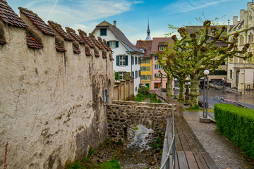 Old street in Zug City along defence wall and water duct of Burg Zug, Switzerland