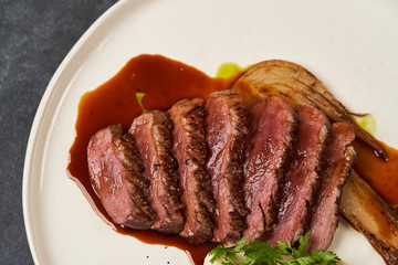 Baked turkey Fillet with Celery Puree and sauce on white plate