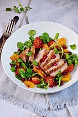 Duck breast fillets steak salad with roasted pumpkin, tomatoes and pomegranate seeds