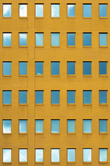 Windows of a yellow brick building texture. Abstraction.