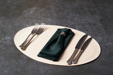 Serving table with napkin and cutlery knives and fork.