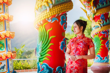 Asian women dressed in Chinese New Year culture costumes around the shrine 